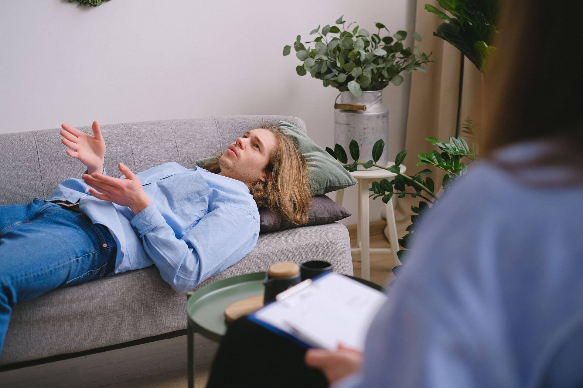 A man sitting in quiet reflection during a grief recovery session